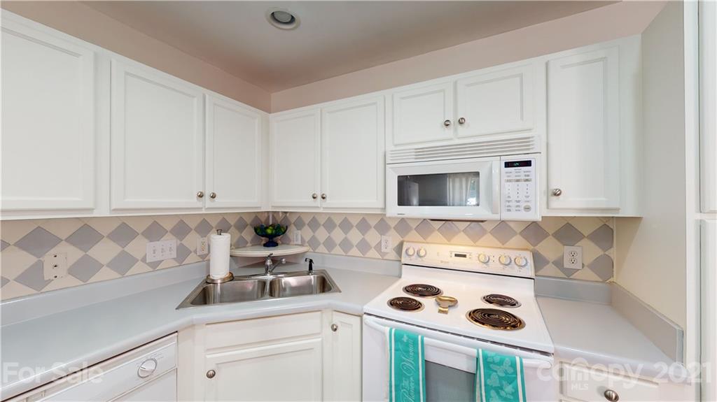 11642 Rabbit Ridge Road Charlotte, NC 28270 - Photo 9 of 45 a kitchen with a cabinets and white appliances