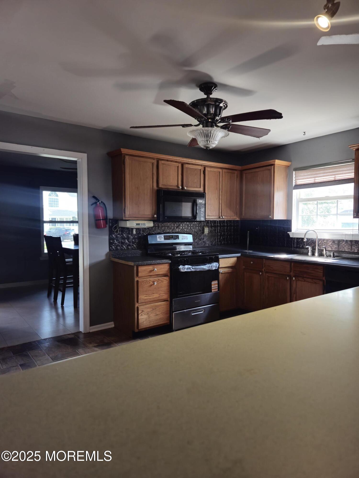 34 Vance Avenue Sicklerville, NJ 08081 - Photo 13 of 30 a kitchen with stainless steel appliances granite countertop a stove sink and cabinets