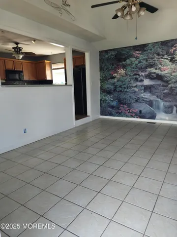 an empty room with windows and entryway