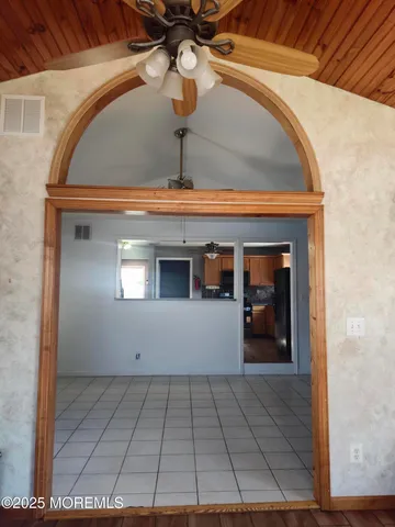 an entryway with wooden floor and a window
