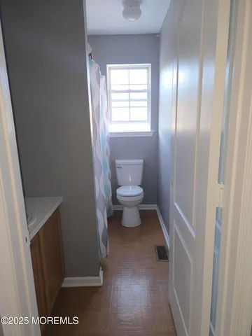 wooden floor in a hall with an empty room