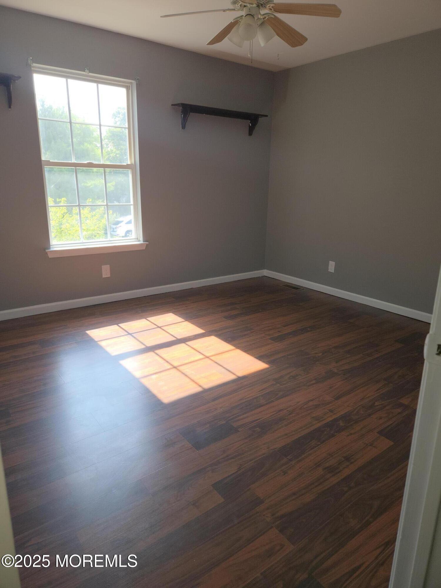 34 Vance Avenue Sicklerville, NJ 08081 - Photo 25 of 30 an empty room with wooden floor and windows