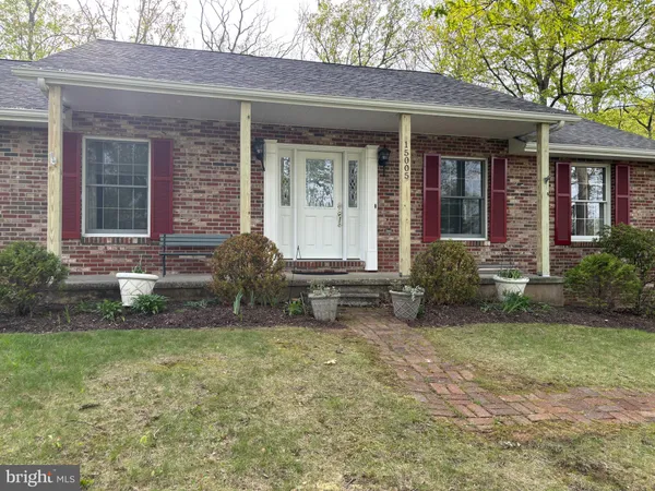 a view of a house with a yard and sitting area