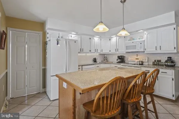 a view of kitchen with sink and refrigerator
