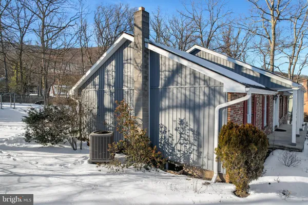 a view of a house with snow on the road