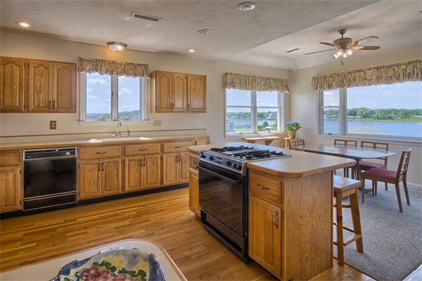 32 Surfside Road Scituate, MA 02066 - Photo 3 of 18 a kitchen with a stove sink and cabinets