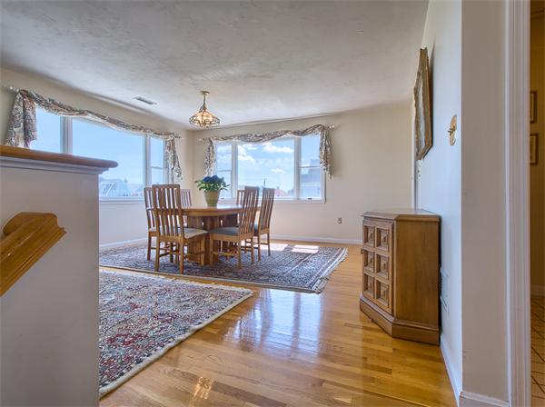 32 Surfside Road Scituate, MA 02066 - Photo 7 of 18 a dining room with furniture a chandelier and wooden floor