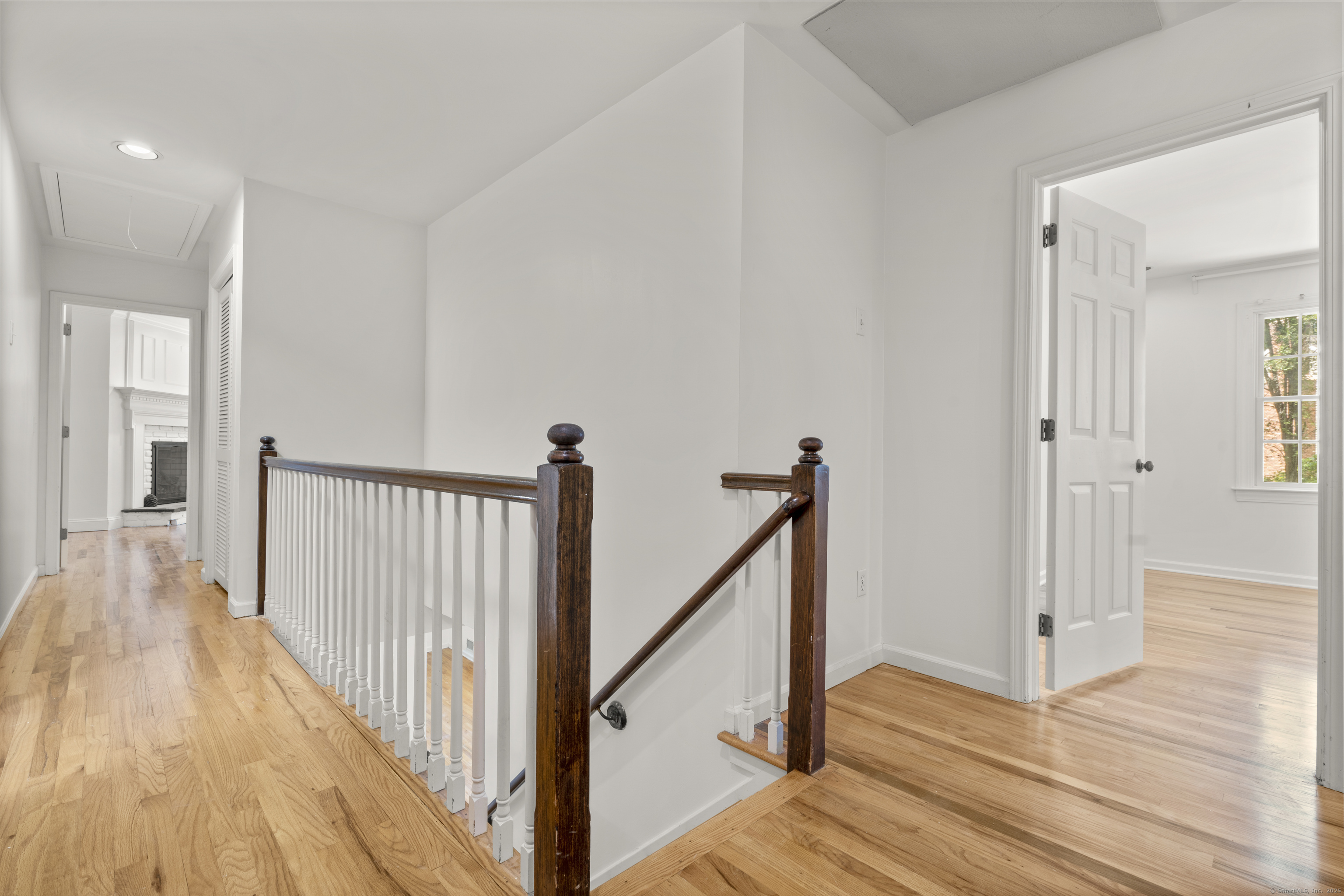 181 Old Boston Road Wilton, CT 06897 - Photo 12 of 30 a view of a hallway with wooden floor and staircase