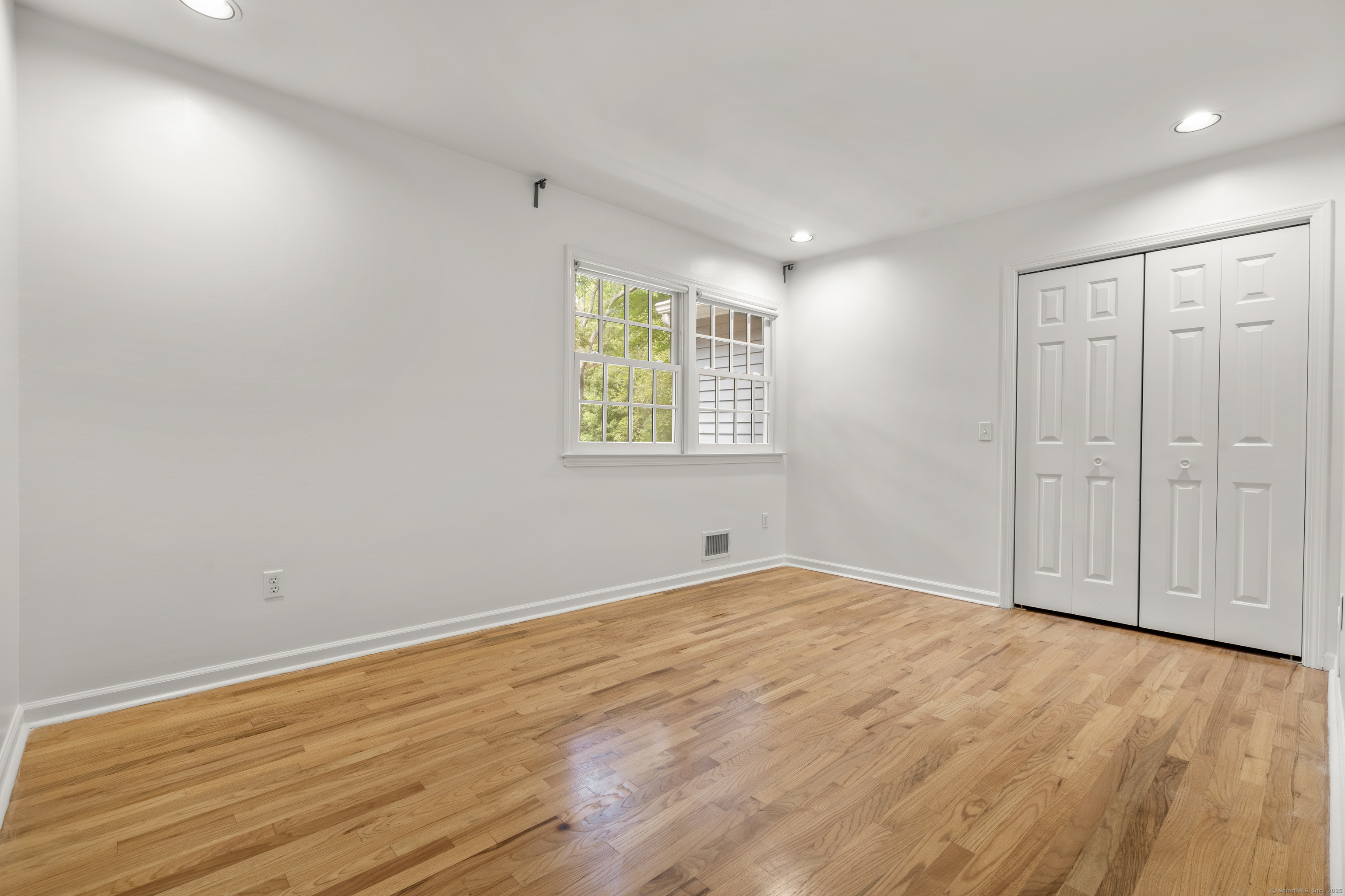 181 Old Boston Road Wilton, CT 06897 - Photo 21 of 30 an empty room with wooden floor and windows