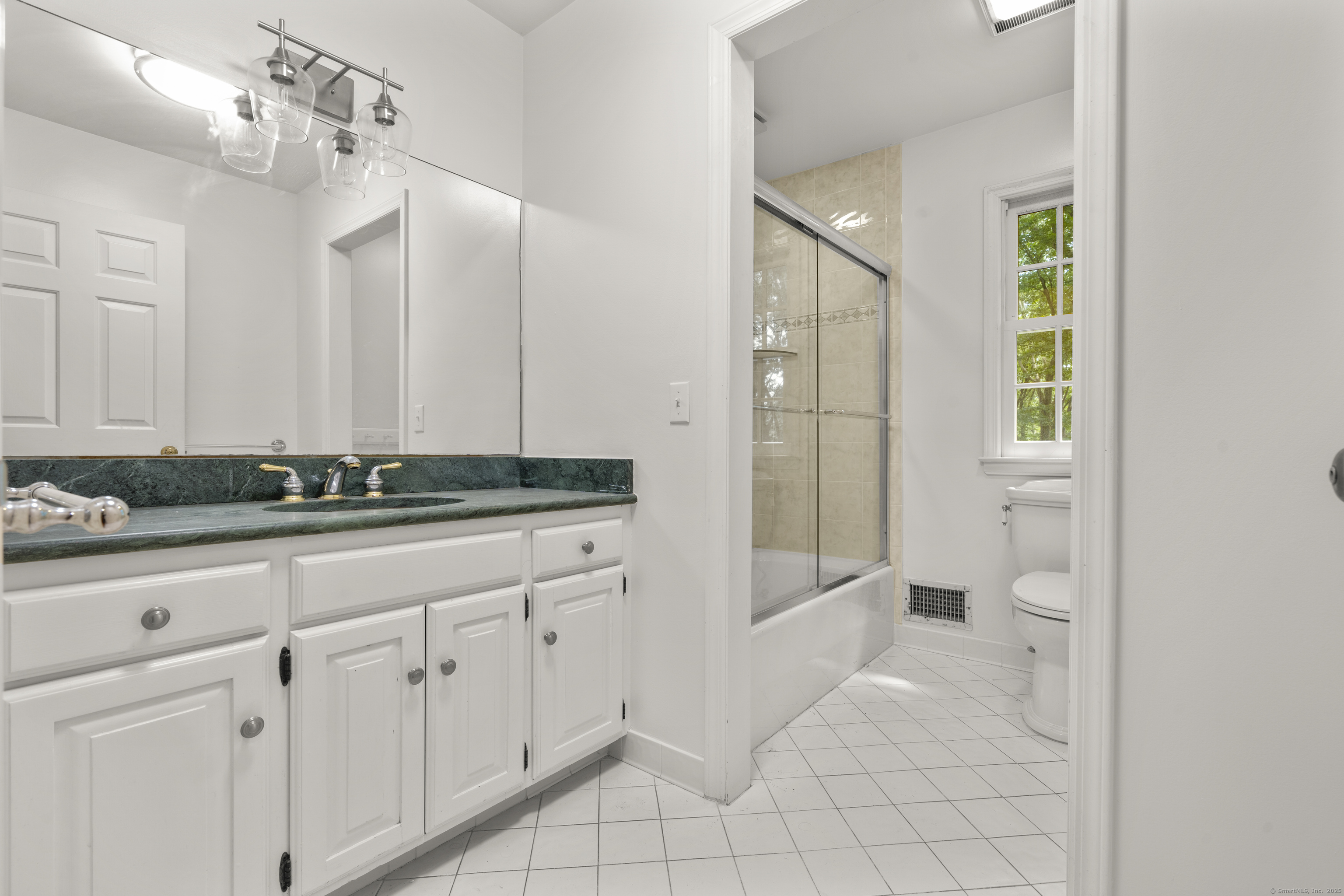 181 Old Boston Road Wilton, CT 06897 - Photo 23 of 30 a bathroom with a granite countertop sink and a mirror