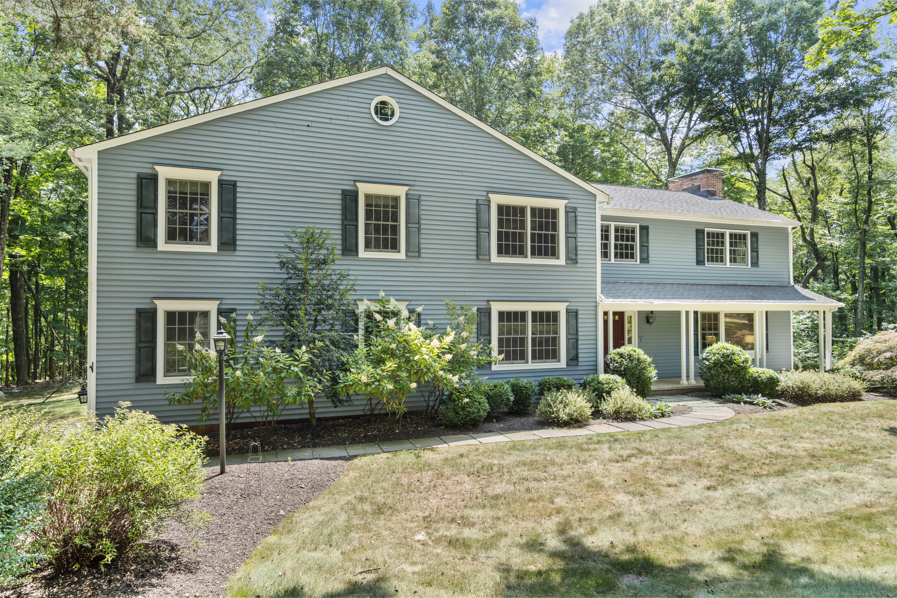 181 Old Boston Road Wilton, CT 06897 - Photo 26 of 30 a front view of a house with a garden