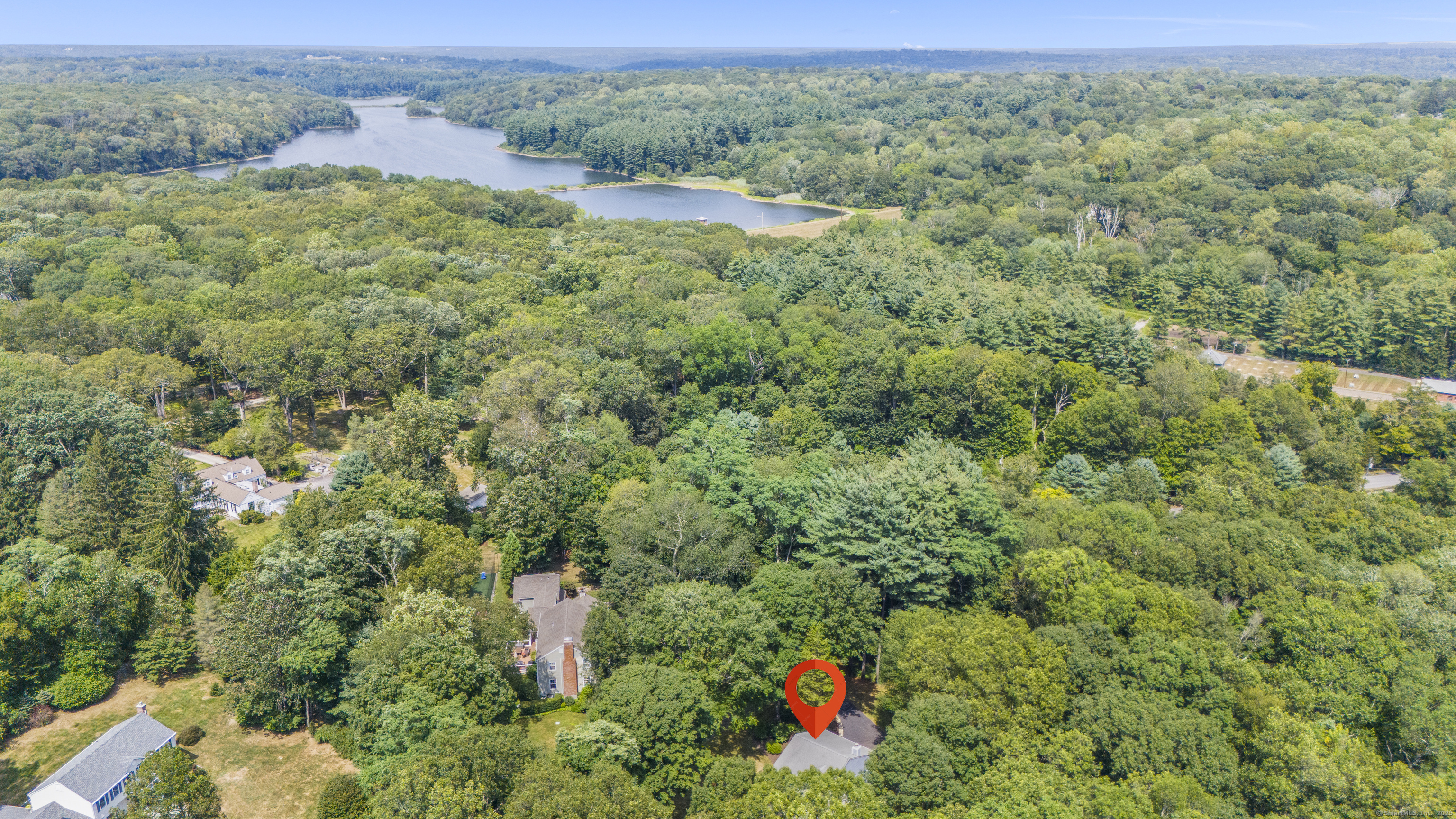 181 Old Boston Road Wilton, CT 06897 - Photo 3 of 30 a view of a lush green forest with trees and some houses