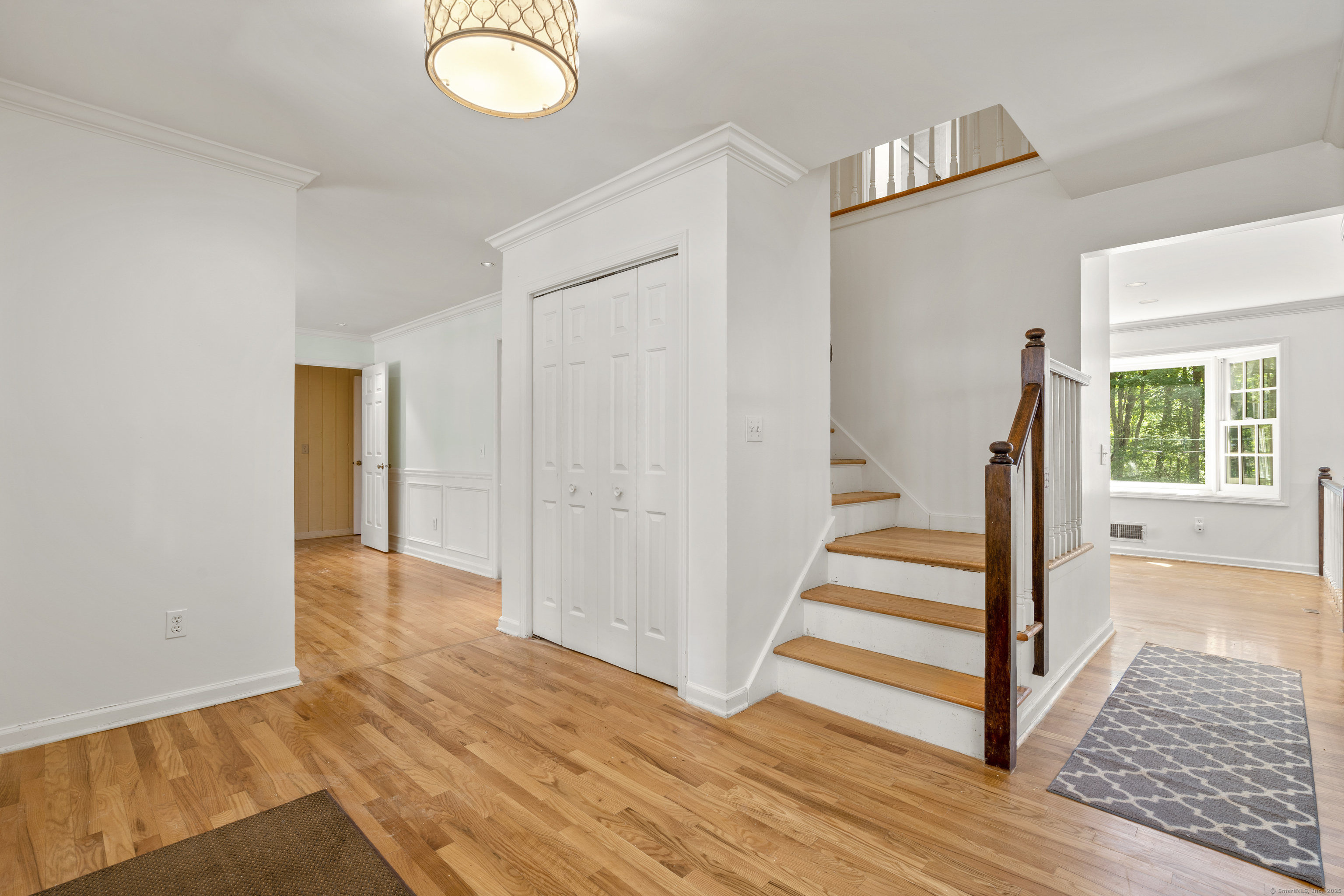 181 Old Boston Road Wilton, CT 06897 - Photo 4 of 30 a view of a hallway with wooden floor and staircase