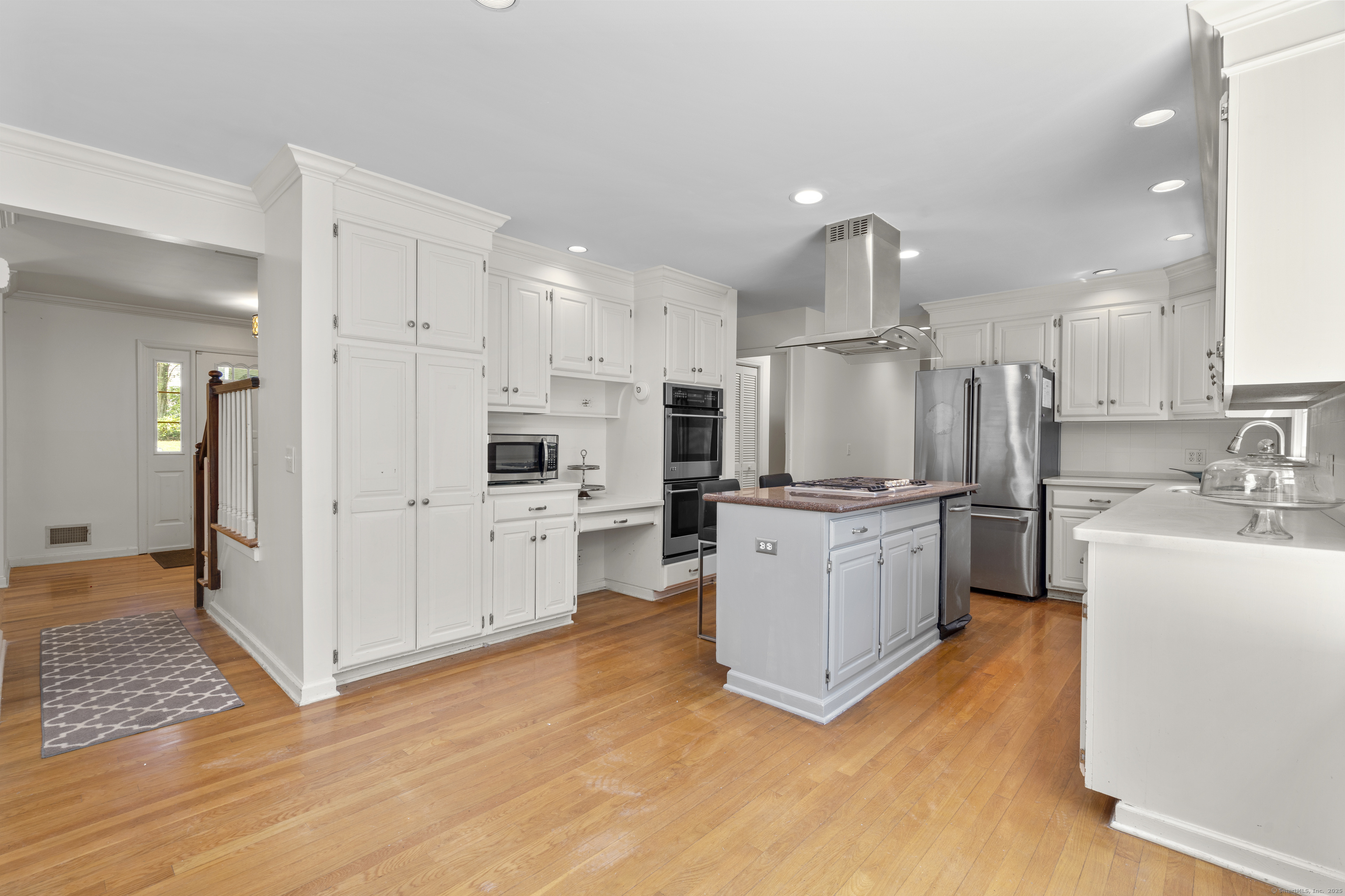 181 Old Boston Road Wilton, CT 06897 - Photo 6 of 30 a large white kitchen with cabinets