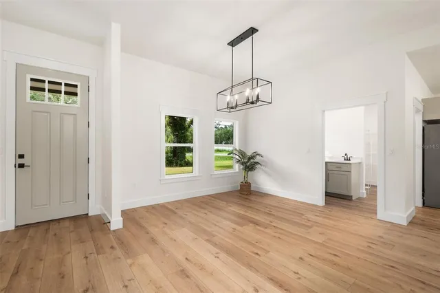 a view of empty room with wooden floor and window