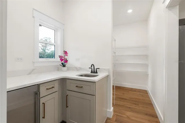 a kitchen with a sink cabinets and window