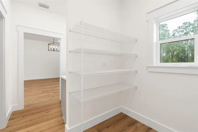 a view of walk in closet with empty racks