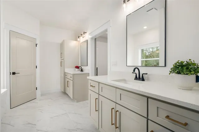 a bathroom with a sink a toilet and mirror