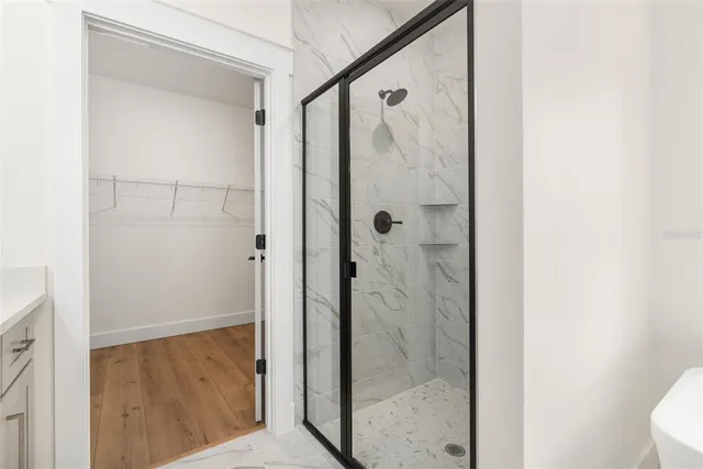 a bathroom with a shower and a sink