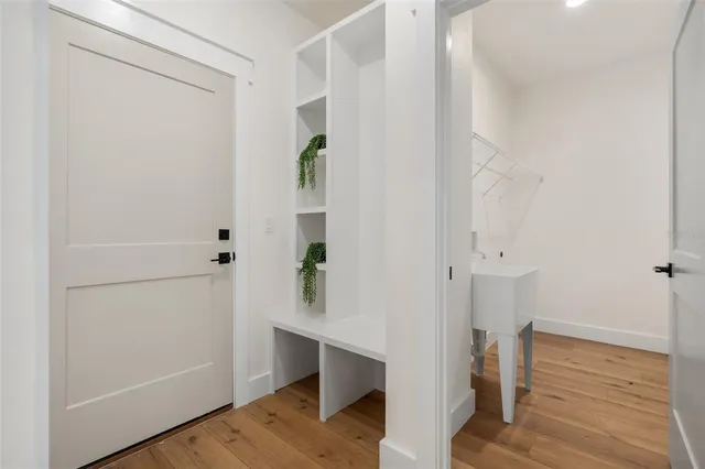 a view of hallway with wooden floor