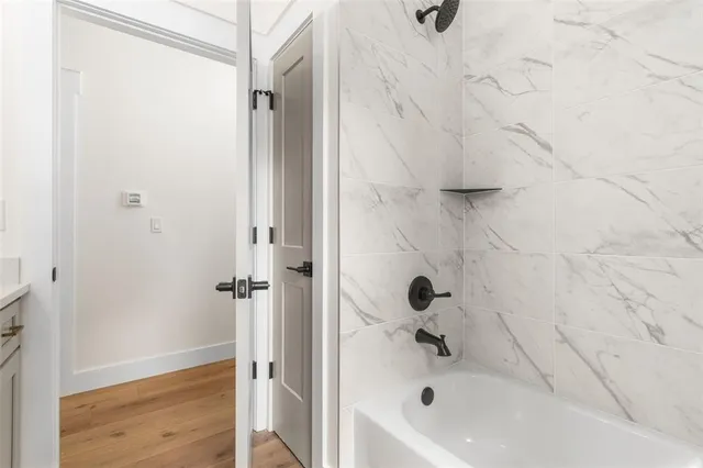 an empty room with a window and wooden floor