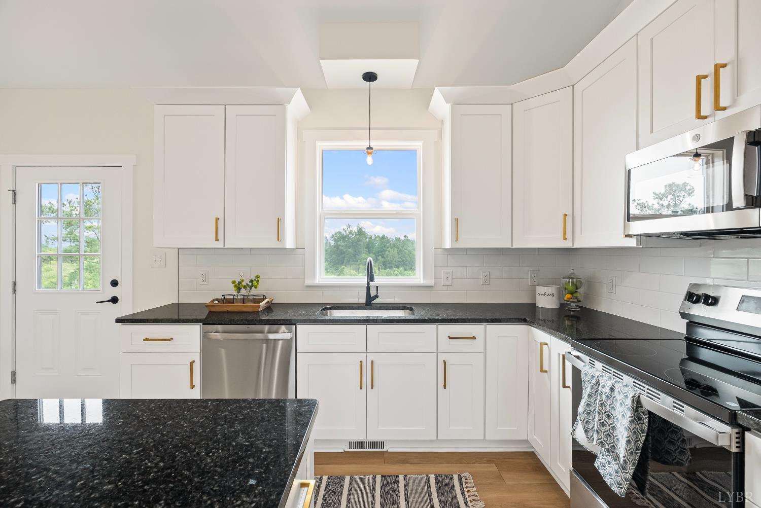 187 Fox Hall Drive Amherst, VA 24521 - Photo 13 of 36 a kitchen with stainless steel appliances granite countertop a stove a sink and white cabinets