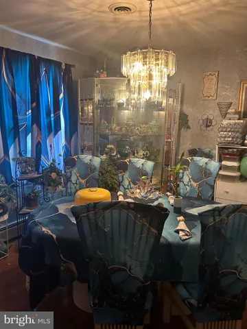 a dining room with furniture and chandelier