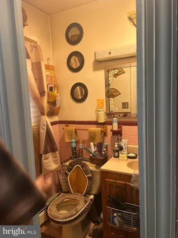 a bathroom with a toilet mirror and tub