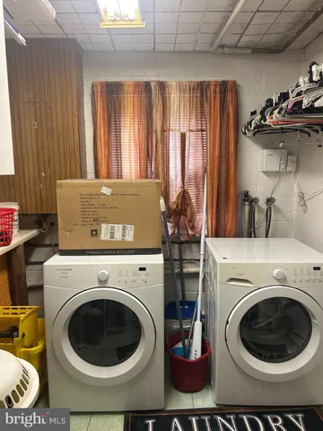 a view of washer and dryer with kitchen in the background