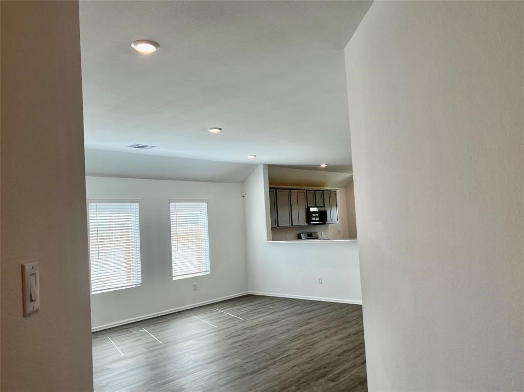 5304 Winding Strm Drive Rosenberg, TX 77469 - Photo 4 of 17 wooden floor in an empty room with a window