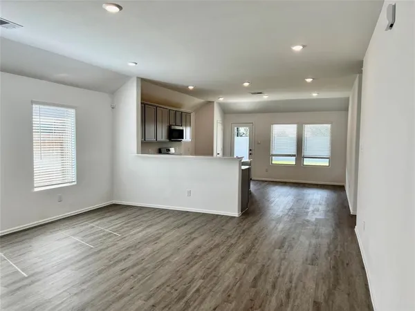 a view of a livingroom with wooden floor and window