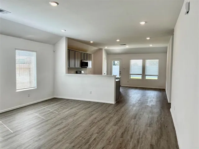 a view of a livingroom with wooden floor and window
