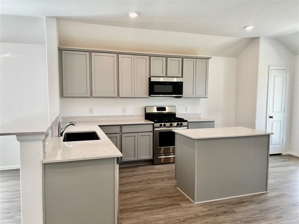 5304 Winding Strm Drive Rosenberg, TX 77469 - Photo 6 of 17 a kitchen with appliances a sink and a microwave