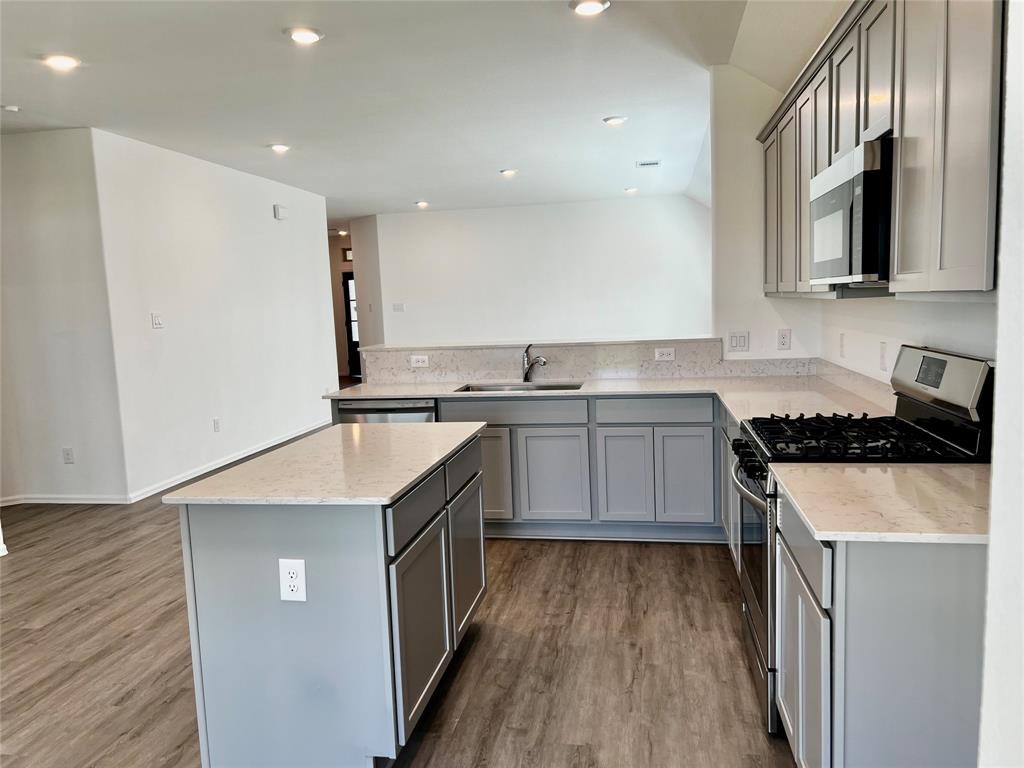 5304 Winding Strm Drive Rosenberg, TX 77469 - Photo 8 of 17 a kitchen with stainless steel appliances granite countertop a sink stove and refrigerator