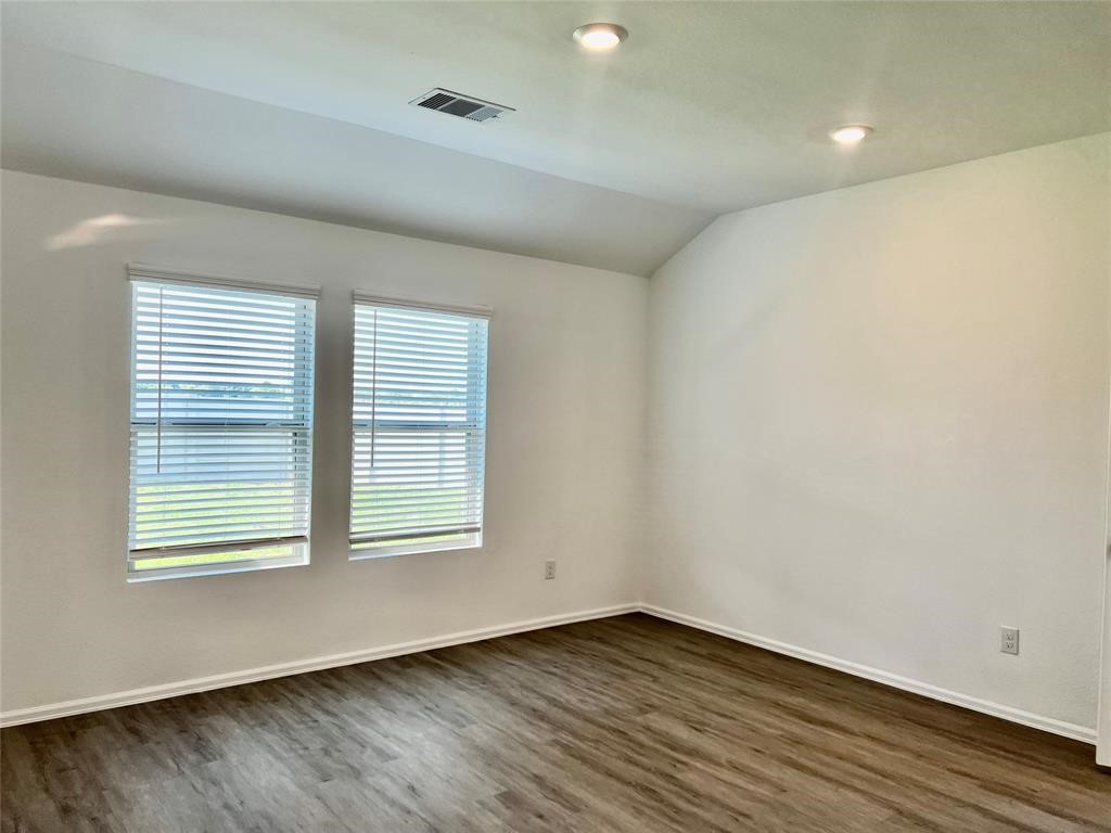 5304 Winding Strm Drive Rosenberg, TX 77469 - Photo 9 of 17 an empty room with wooden floor and windows
