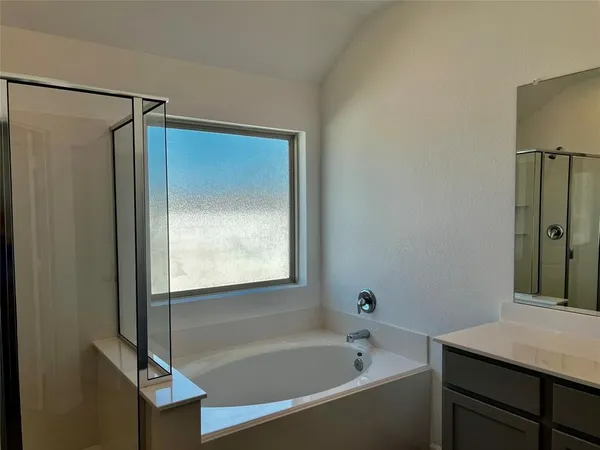 a bathroom with a bathtub and a shower