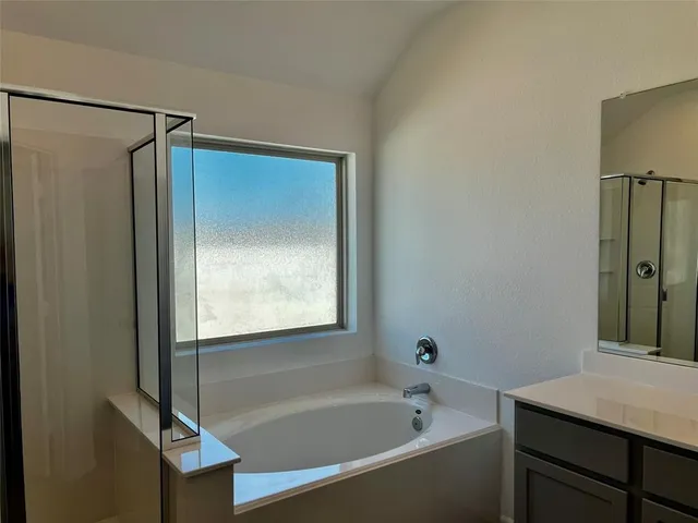 a bathroom with a bathtub and a shower