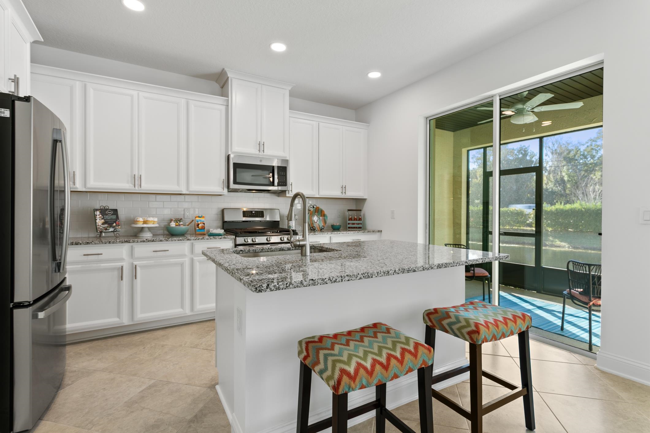 241 Grand Ravine Drive St. Augustine, FL 32086 - Photo 13 of 37 a kitchen with stainless steel appliances granite countertop a stove a sink and a refrigerator