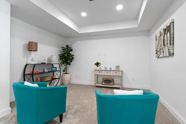 a living room with furniture and a potted plant