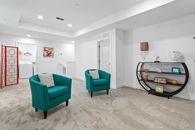 a living room with furniture and a mirror