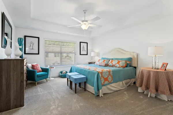 a bedroom with a bed and a couch
