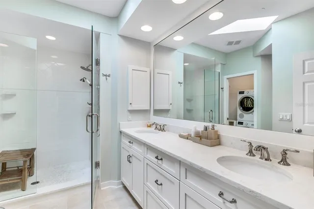 a bathroom with a shower sink and mirror