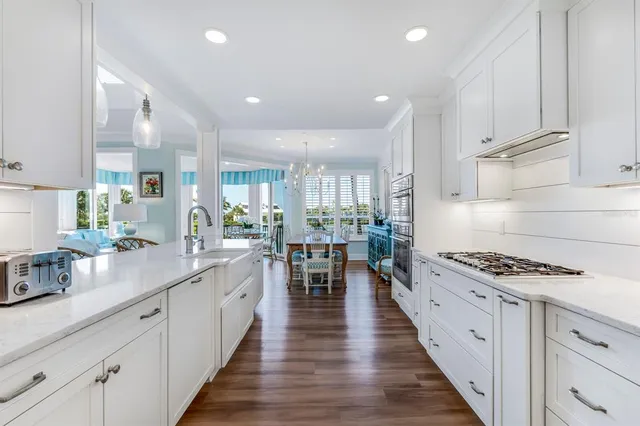 a kitchen with counter top space stove sink and cabinets