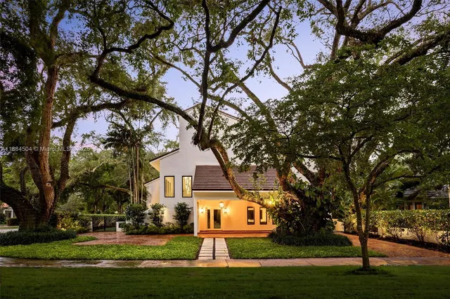 a front view of a house with a garden