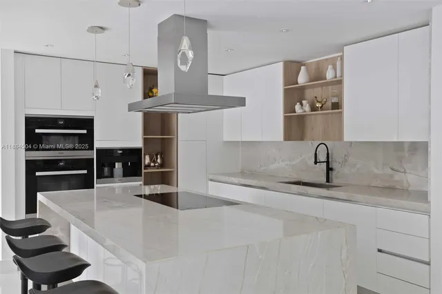 a kitchen with stainless steel appliances granite countertop a sink and a refrigerator