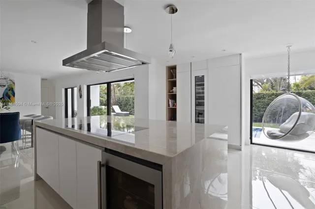 a kitchen with stainless steel appliances granite countertop a stove and a wooden floors