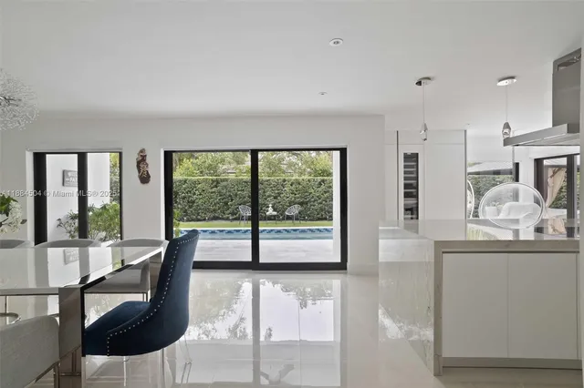 a living room with furniture and large windows