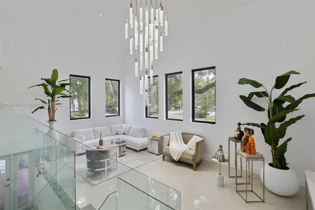 a living room with furniture potted plant and window