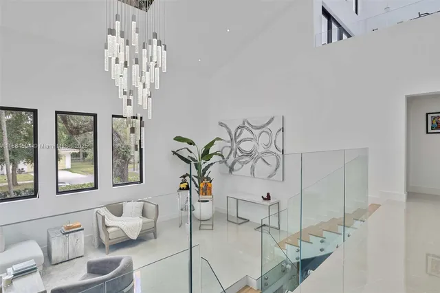 a living room with furniture and chandelier