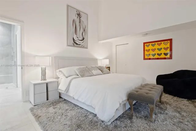 a bedroom with a bed and wall painting